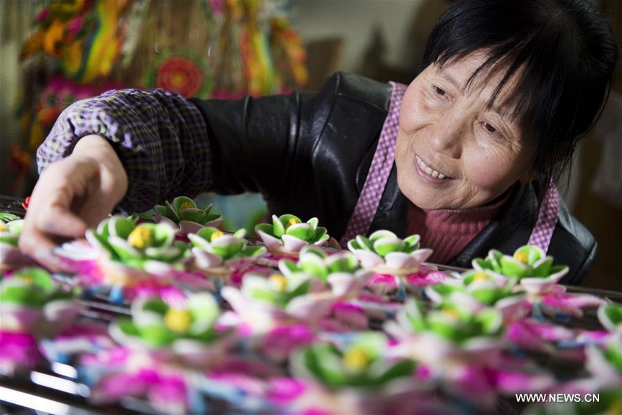 الصورة: امرأة صينية تعرض مهارتها في صنع الخبز التقليدي في مقاطعة بشمال غربي الصين