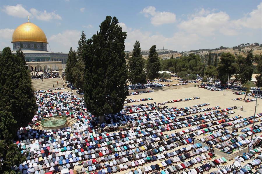 الصورة: المسلمون يؤدون أول صلاة جمعة في رمضان خارج مسجد "قبة الصخرة" في القدس