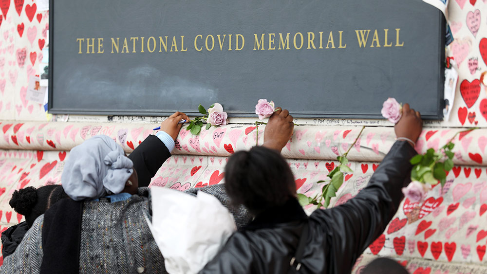 أشخاص يضعون الزهور على النُصب التذكاري الوطني لضحايا كوفيد-19 في لندن