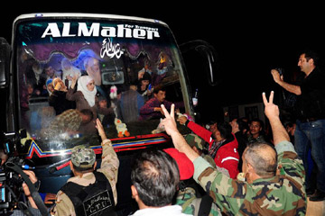 وصول أول حافلة تنقل مسلحين ومعتقلين لدى جيش الإسلام إلى ممر الوافدين