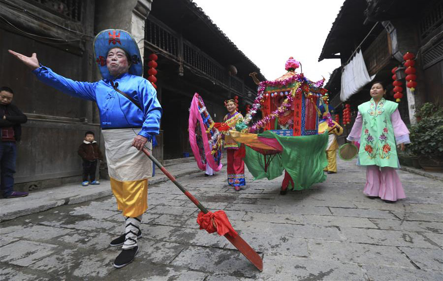 العرض الفني للاحتفال بعيد الربيع التقليدي في بلدة قديمة بوسط الصين